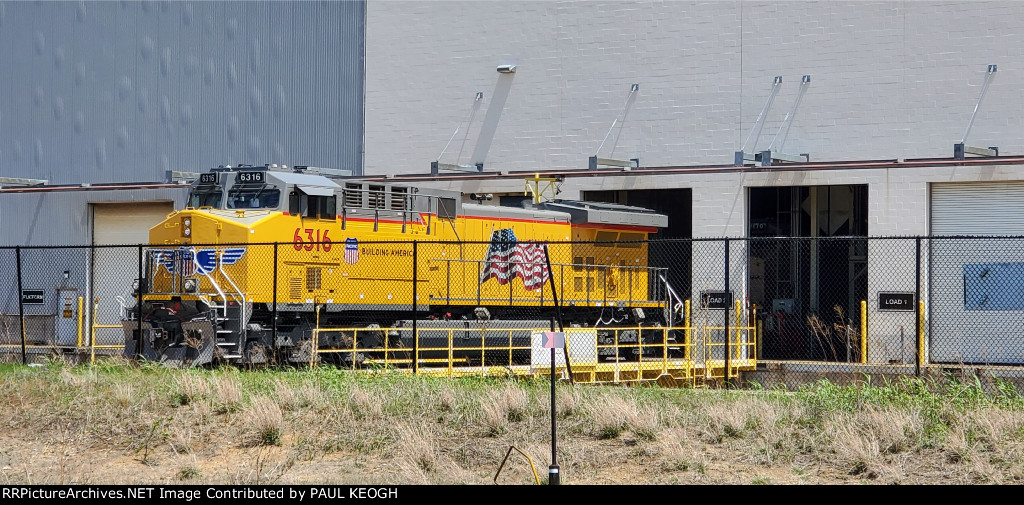 UP 6316 on the 250,000lb transfer dolly being moved to load 1 door for further checks before delivery to UP